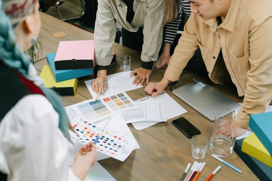 Small business owner reviewing branding proofs and mood boards in Malaysia