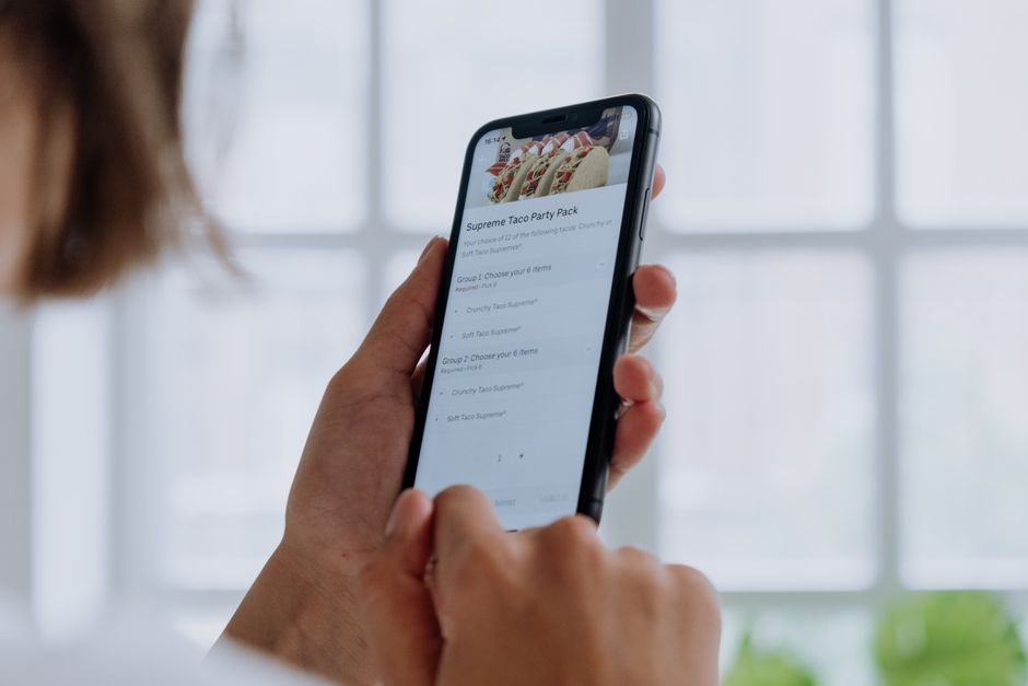 Customer ordering food through a WhatsApp catalog on a smartphone