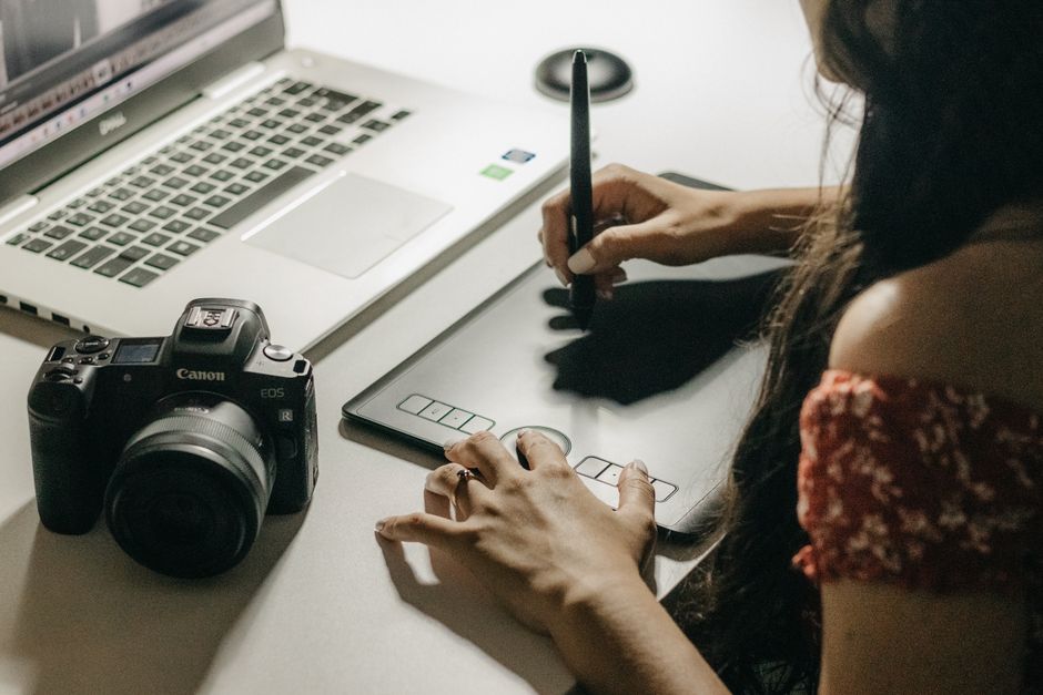 Designer refining a brand identity on a graphics tablet in Malaysia