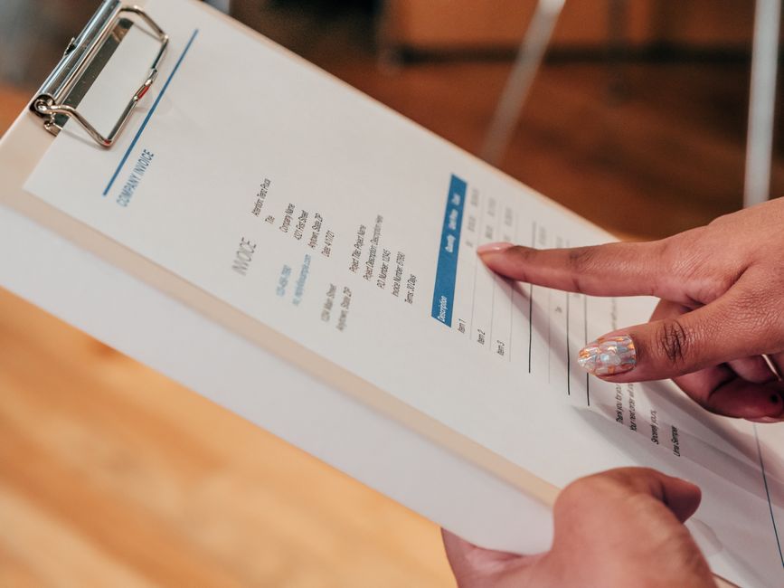 Online seller checking invoice records on a laptop