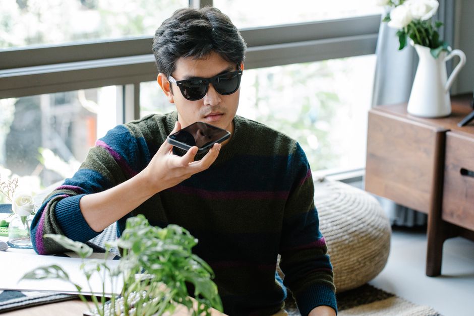 Person talking to phone using voice search