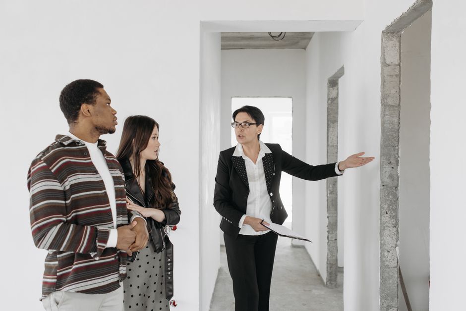 Real estate agent showing an empty unit to a couple