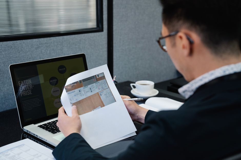 Business owner reviewing a branding agency proposal at a desk