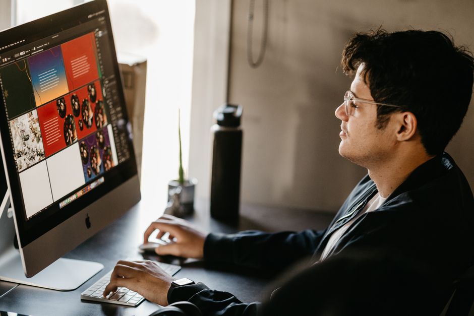 Creative team reviewing logo design concepts on a laptop