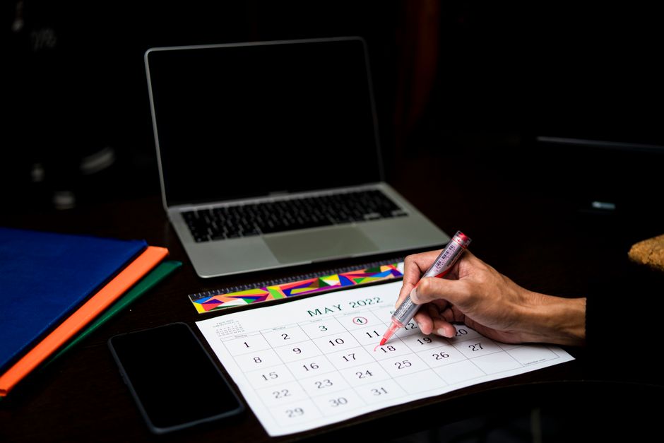 Malaysian business owner checking a booking calendar